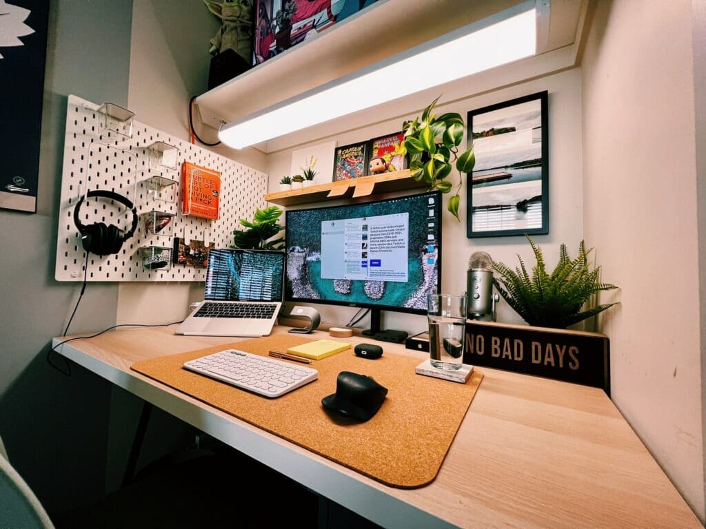 A desk with a laptop connected to a monitor with a well organised set of tools that could be helped by easy communication tools.